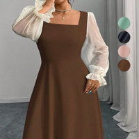 The Woman Is Wearing A Black Mesh-spliced Dress With Bubble Sleeves