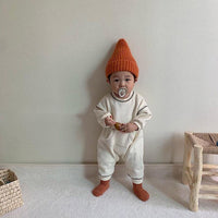 The baby's patterned crawling suit in contrasting colors