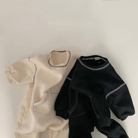 The baby's patterned crawling suit in contrasting colors
