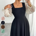 The Woman Is Wearing A Black Mesh-spliced Dress With Bubble Sleeves