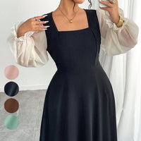 The Woman Is Wearing A Black Mesh-spliced Dress With Bubble Sleeves