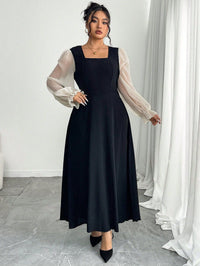 The Woman Is Wearing A Black Mesh-spliced Dress With Bubble Sleeves