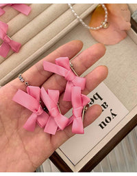 8 Pink Ribbon Bow Hair Clips On The Forehead