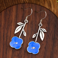 Elegant Deep-blue Stud Earrings With Delicate Floral Accents