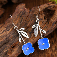 Elegant Deep-blue Stud Earrings With Delicate Floral Accents