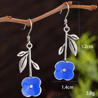 Elegant Deep-blue Stud Earrings With Delicate Floral Accents
