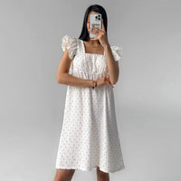 White Sleeveless Dress With Heart Print And Ruffle Trim